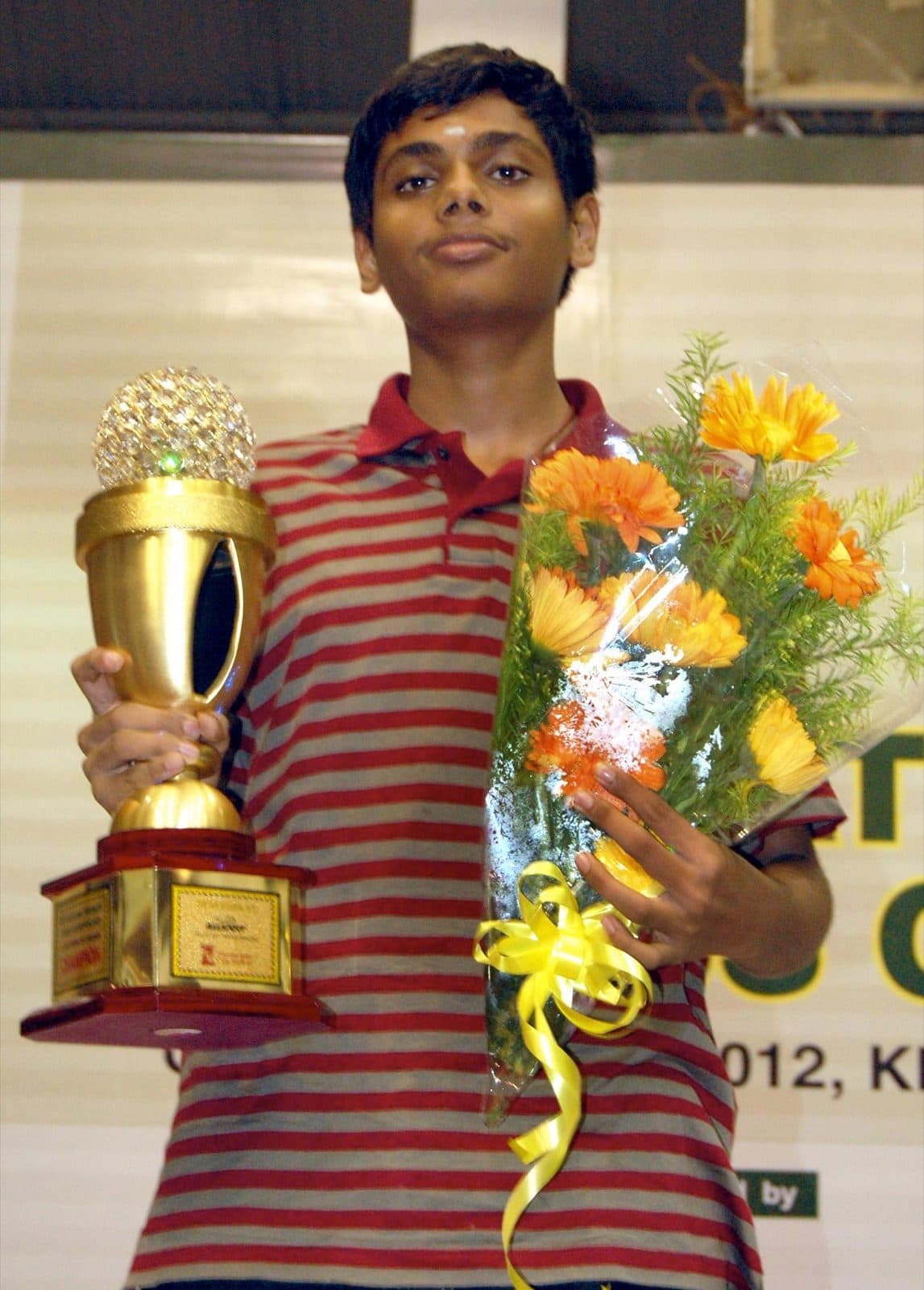 Akash Ganesan holding the National A 2012 trophy